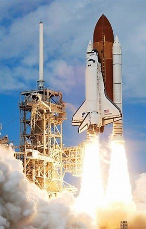Space Shuttle lifting off from the launch pad